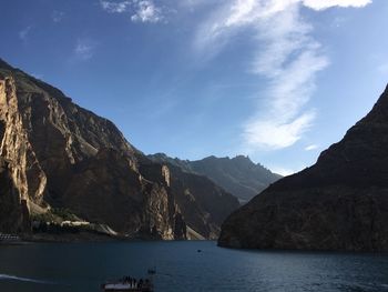 Scenic view of sea and mountains against sky