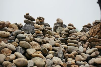 Close-up of pebbles on beach against clear sky