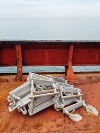 Carving on metallic structure at beach against sky