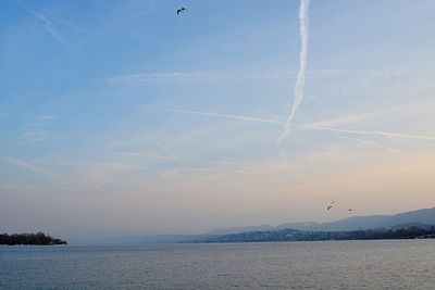 Scenic view of calm sea against cloudy sky