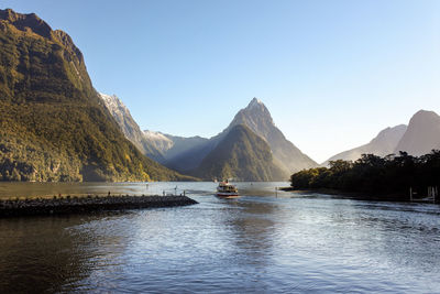 Scenic view of lake and mountains against clear sky