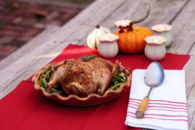 Close-up of roast chicken in container on table