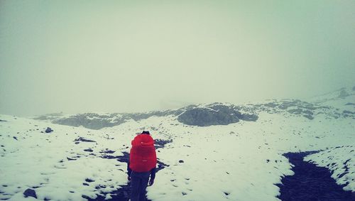 People sitting on snow covered mountain