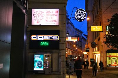 Information sign on illuminated building at night