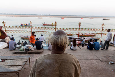 Rear view of people looking at sea