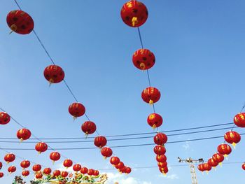 Low angle view of lanterns hanging against clear sky