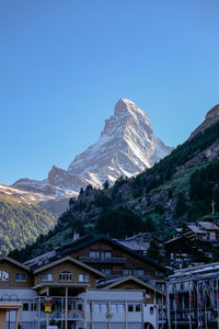 Scenic view of snowcapped mountains against clear blue sky