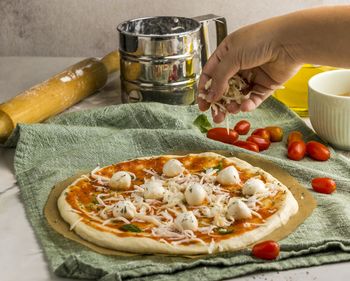 Cropped hand of person preparing food