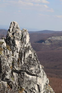 Rock formation on landscape against sky
