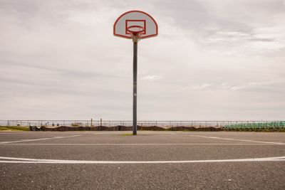 Empty road against cloudy sky