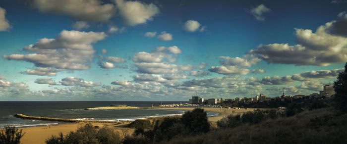 Panoramic view of sea and city against sky