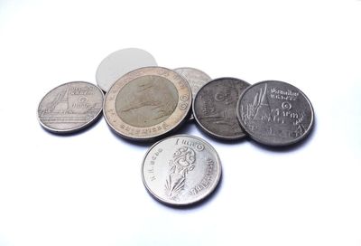 High angle view of coins on white background