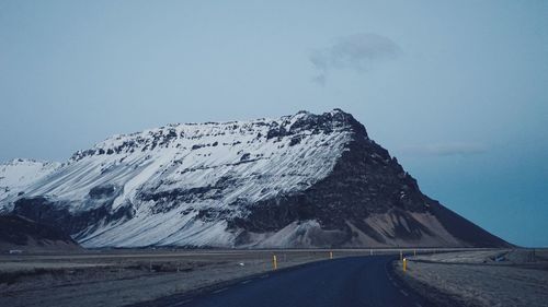 Scenic view of snowcapped mountains against clear sky