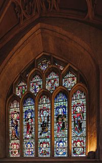 Low angle view of ornate glass window in building