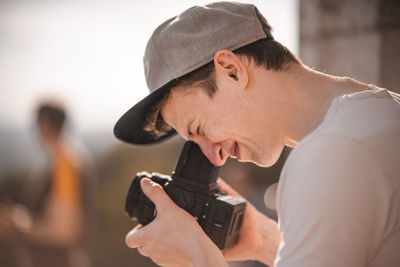 Portrait of young man holding camera