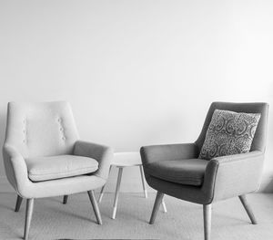 Empty chair on table against wall at home