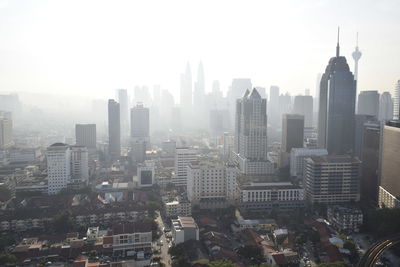 Aerial view of modern buildings in city against sky