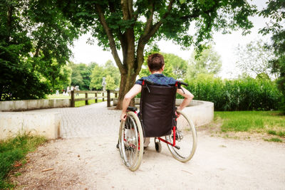 Rear view of man riding bicycle