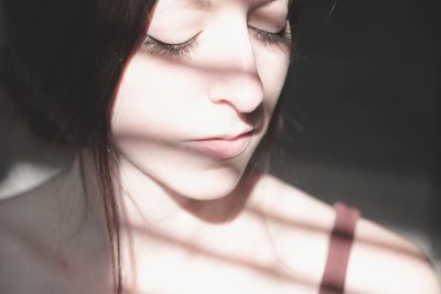 Close-up of young woman with eyes closed