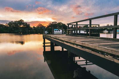 Bridge over river against sky during sunset