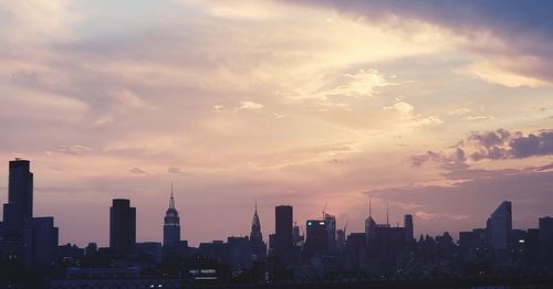 Scenic view of buildings against sky during sunset