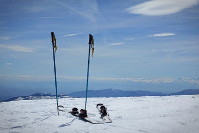 People skiing on snow covered mountain against sky