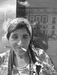Portrait of woman standing on street in city