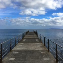 Pier over sea against sky
