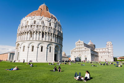 People at piazza dei miracoli against sky