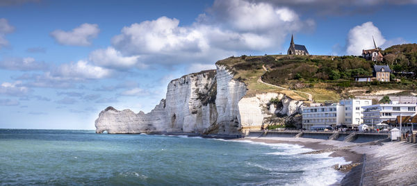 Panoramic view of sea and buildings against sky at etretat, famous travel place in france