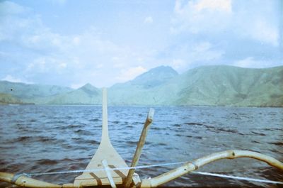 Close-up of sea against mountain range