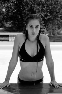 Portrait of woman sitting in swimming pool