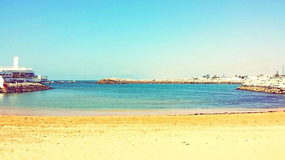 VIEW OF BEACH AGAINST BLUE SKY