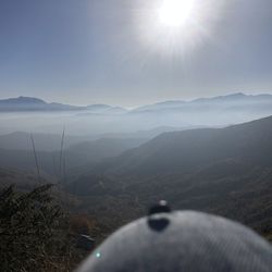 Scenic view of mountains against sky on sunny day