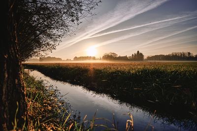 Scenic view of lake against sky during sunset