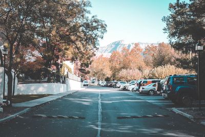 Cars on road in city against sky