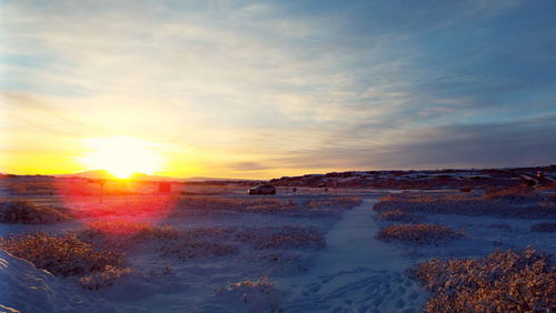 Scenic view of beach against sky during sunset
