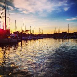 Boats in sea at sunset