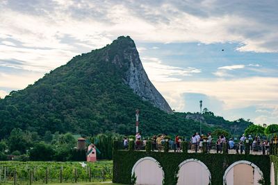 Group of people on mountain against sky