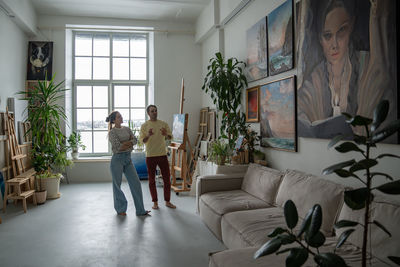 Side view of young woman standing in corridor