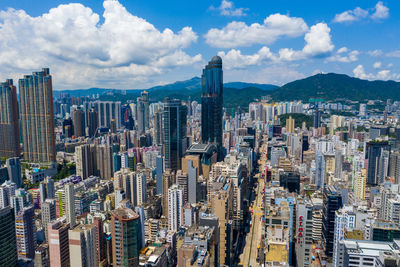 Aerial view of buildings in city against sky