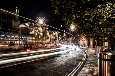 Illuminated light trails on street in city at night