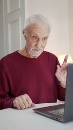 Senior man using laptop at home