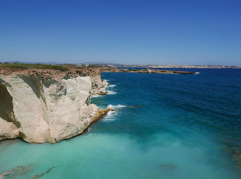 Scenic view of sea against clear blue sky