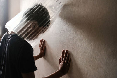 Midsection of woman standing against wall