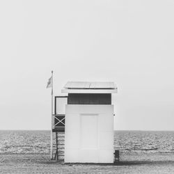 Lifeguard hut on beach against sky