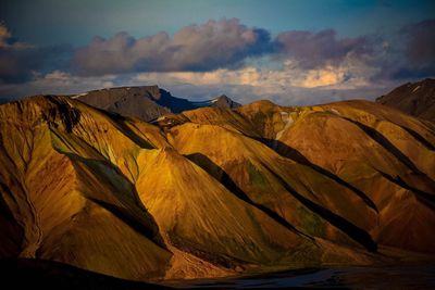 Scenic view of mountains against cloudy sky