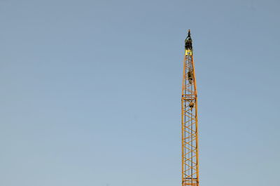 Low angle view of communications tower against clear sky