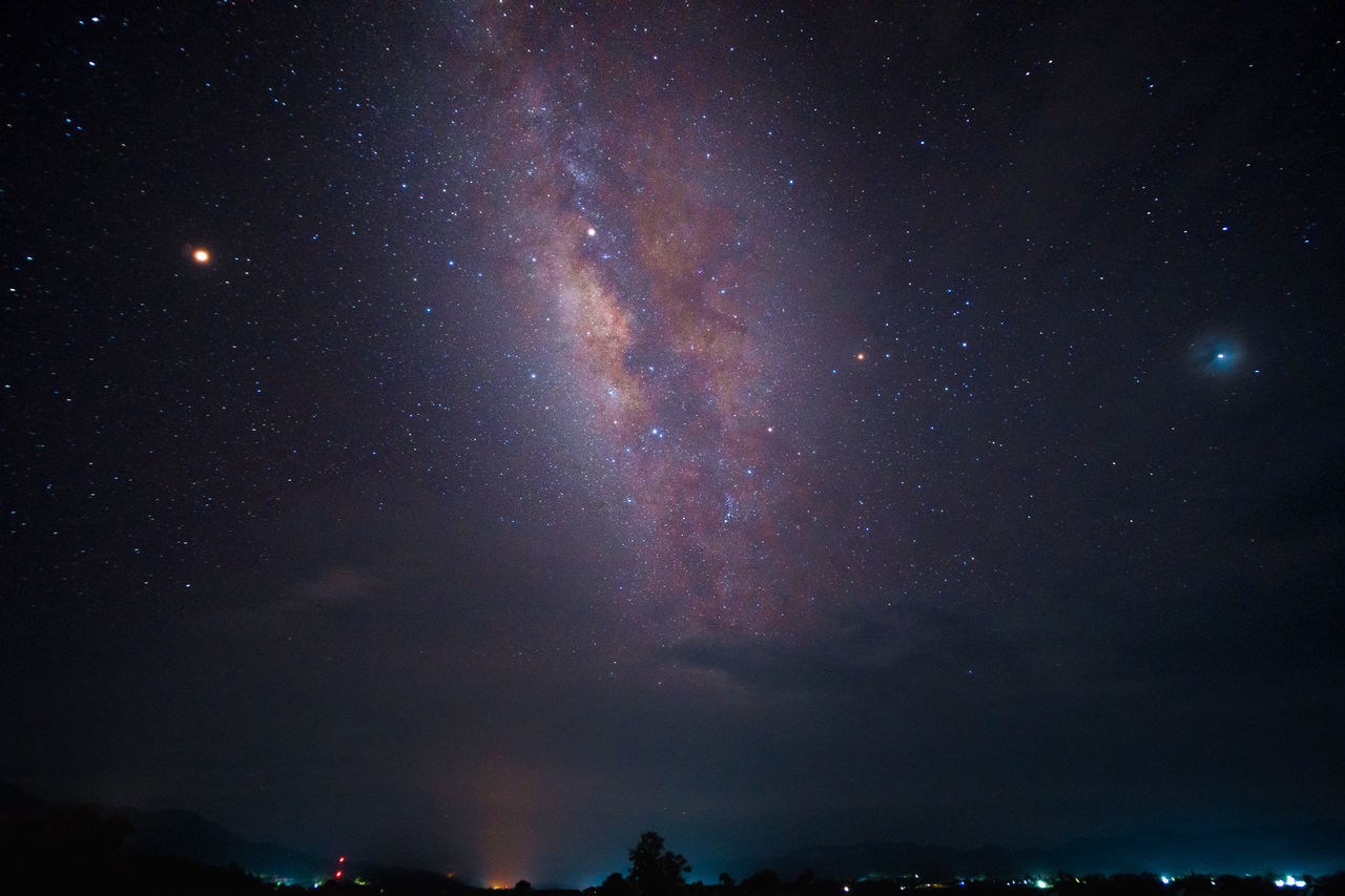 LOW ANGLE VIEW OF STAR FIELD AGAINST SKY