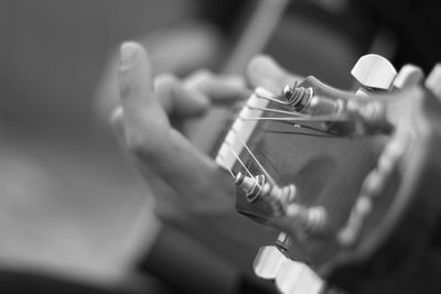 Close-up of hand playing guitar